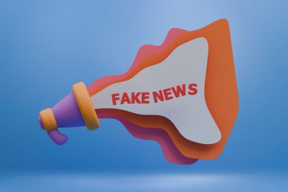 Ilustração 3D de um megafone colorido com a expressão “Fake News”, representando a propagação de desinformação na mídia digital.
